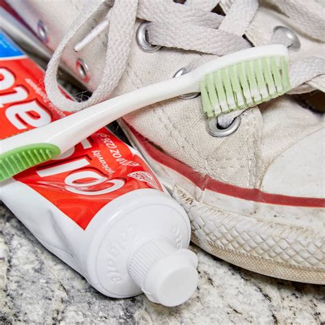 cleaning sneakers with toothbrush.